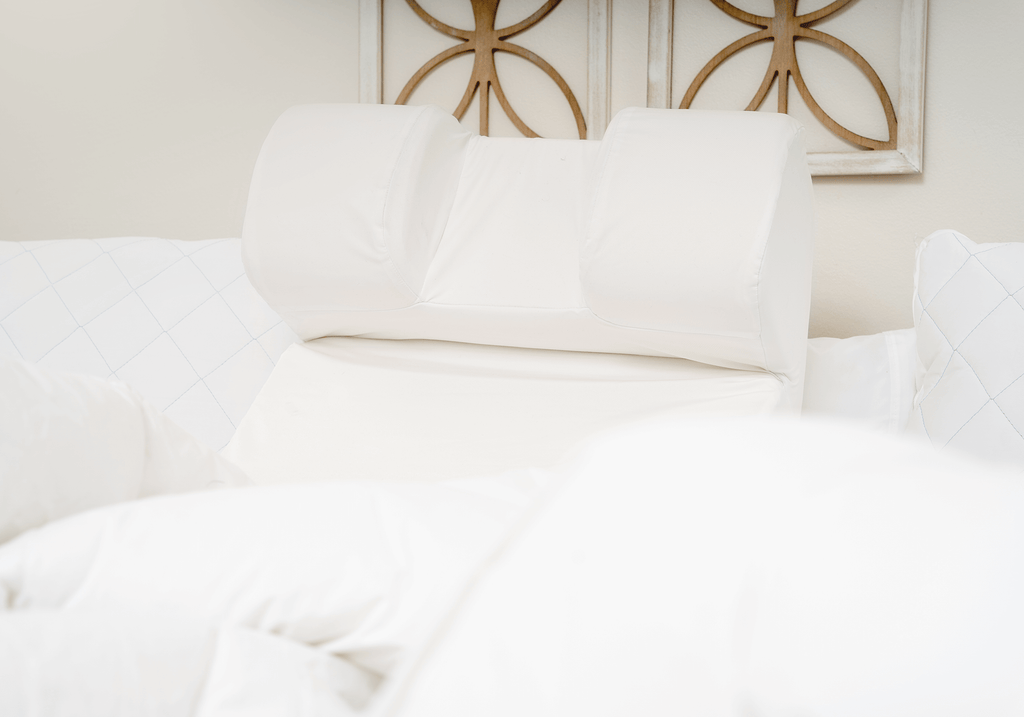 The Restinator pillow at the head of an elegant bed