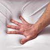 Hand pressing on anti snoring pillow | The Snorinator 